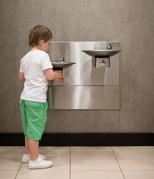 A child using a clean and safe water fountain