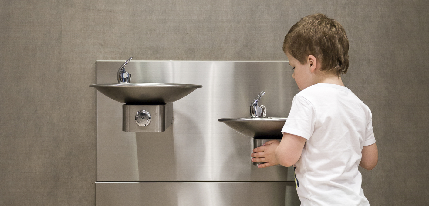 A child using a clean and safe water fountain